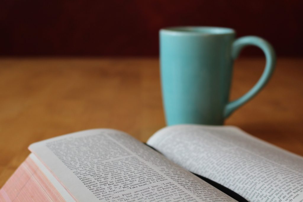 Bible with cup of coffee.