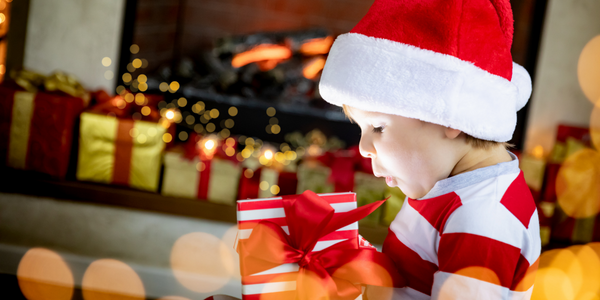 Little boy opening a Christmas gift.