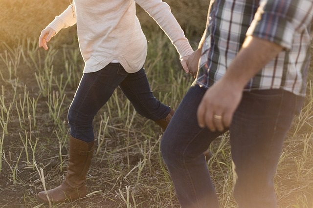 Couple walking in field.