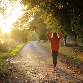 A woman walking down a road.