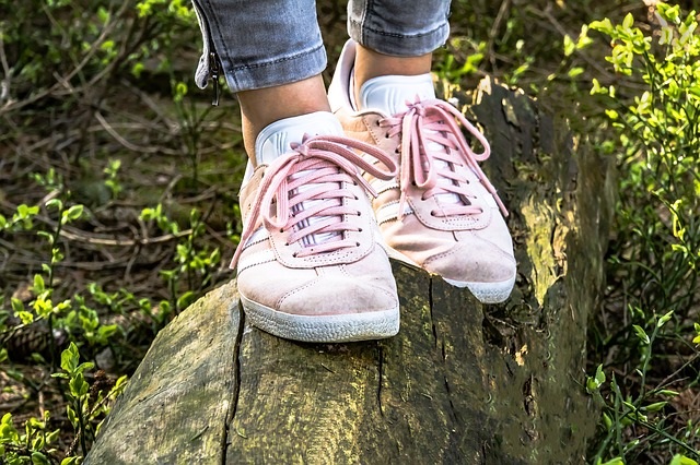 Woman walking on log.
