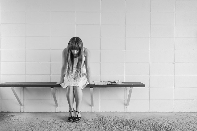 Tired woman sitting on a bench.