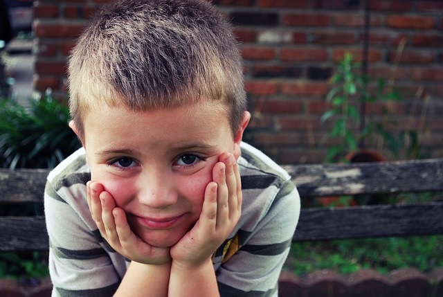 Boy leaning on hands.