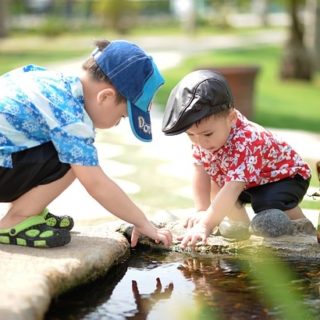 Two boys playing in the water.