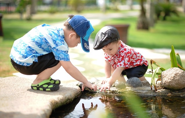 Two boys playing in the water.