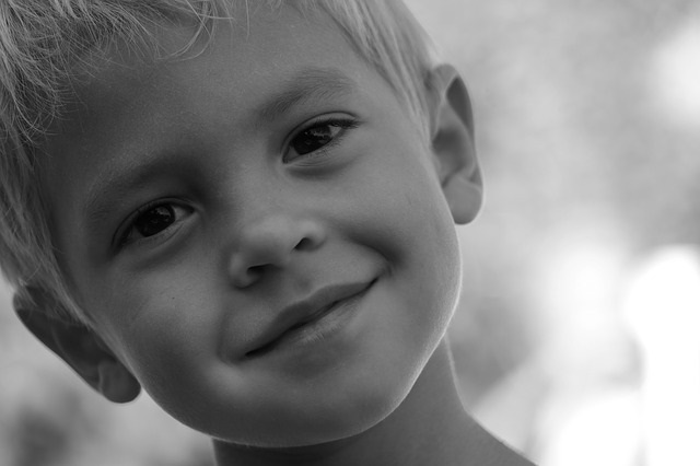 Black and white close up of a little boy.