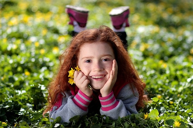 Girl laying in the flowers.