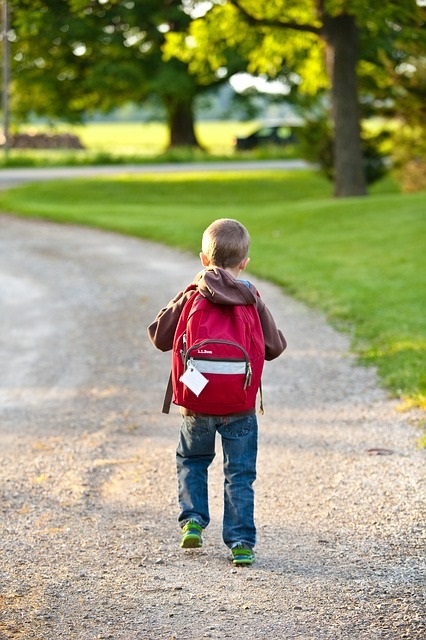 Kid holding backpack hotsell