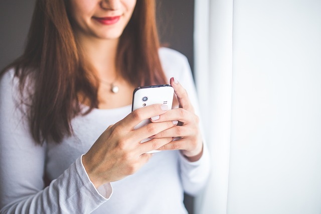 woman on facebook on cell phone