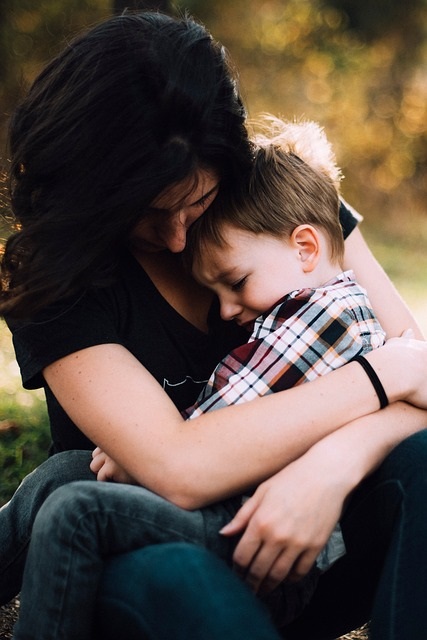 Mom and son hugging.