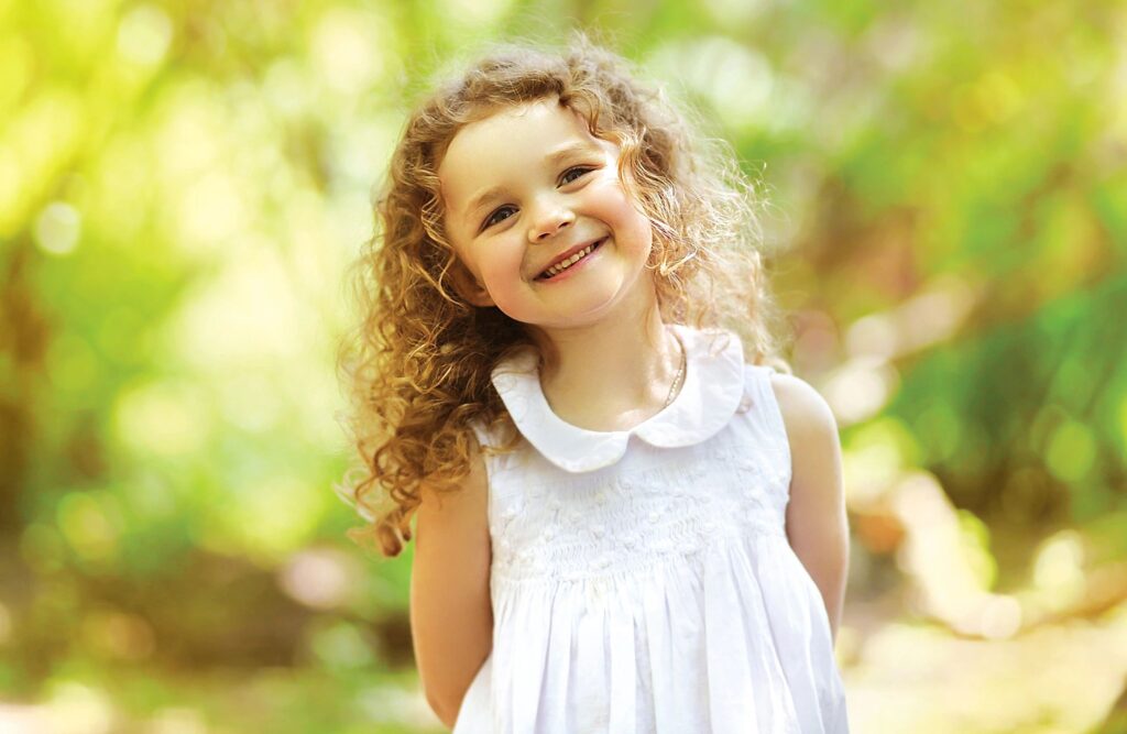 Little girl standing in the sun.