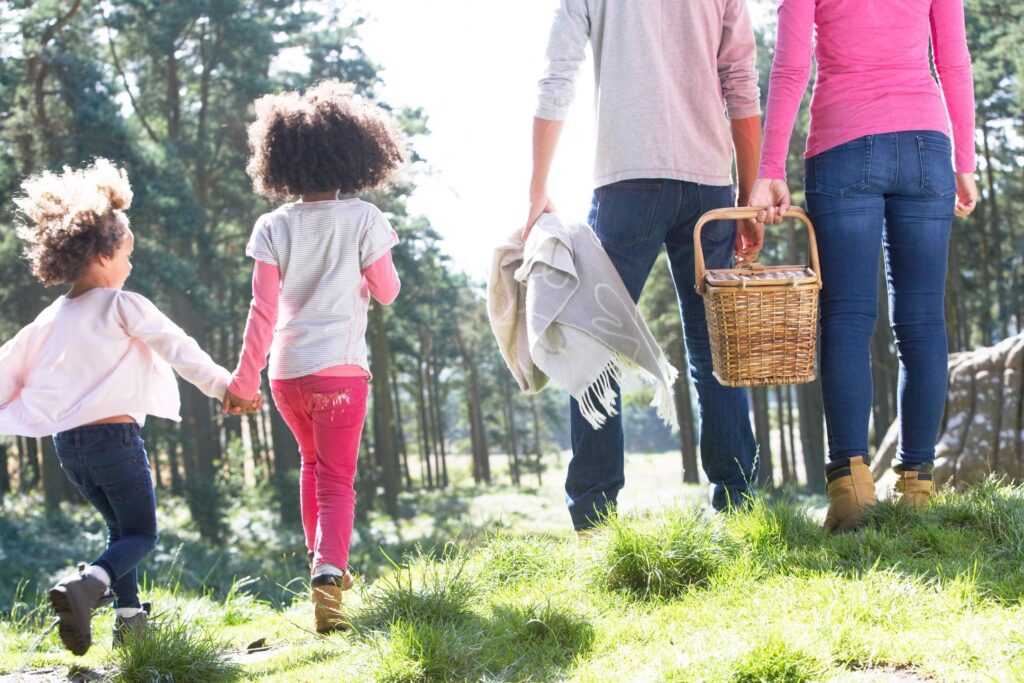 Couple walking with children to picnic.