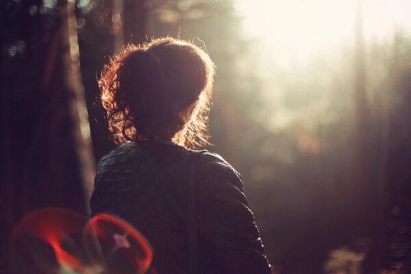 women sitting outside looking into the sun