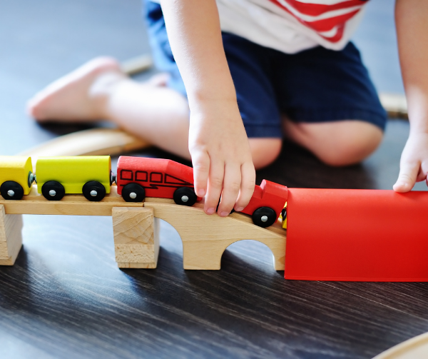 Child Playing with a Train Set