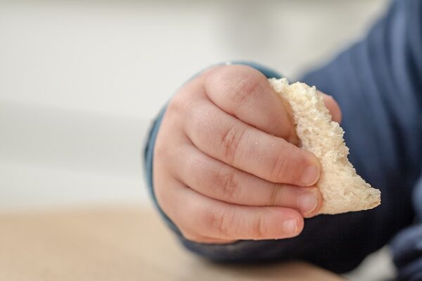 Child eating a snack during church.