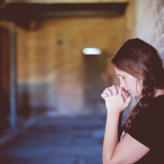 Woman praying in the church.