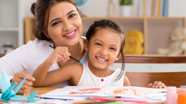 Adult and child painting for summer learning.