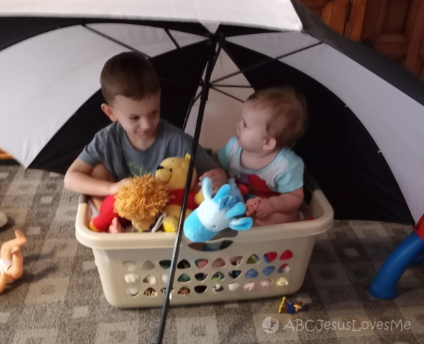 Siblings have play-based learning with Noah's Ark.