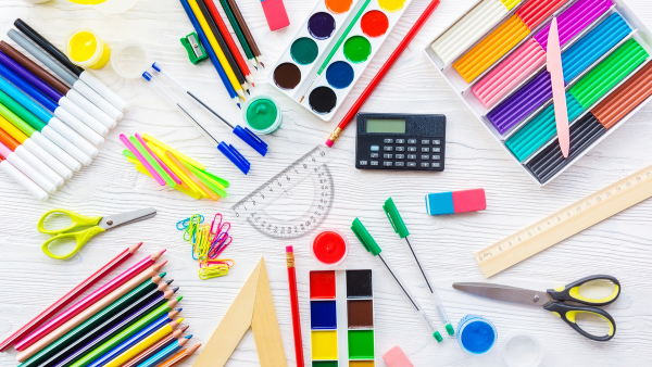 A desk full of school supplies.