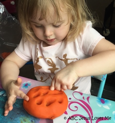 Little girl playing with playdough