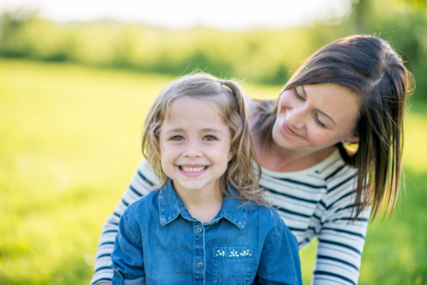 Mom and child smiling.