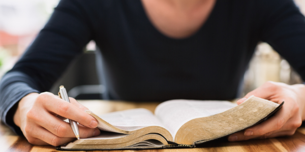 Women with her Bible and pen.