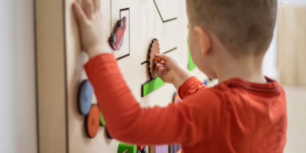 Little boy playing with toy during early intervention therapy.