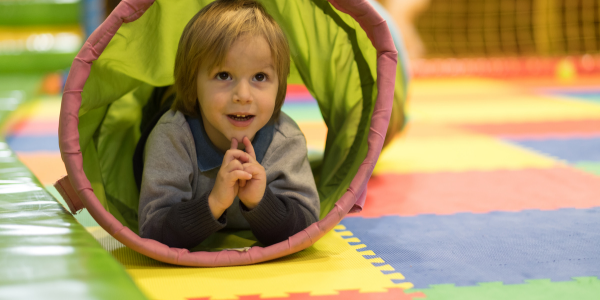 Little boy in tunnel during early intervention therapy.