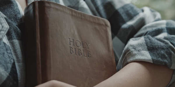 Woman holding a Bible.