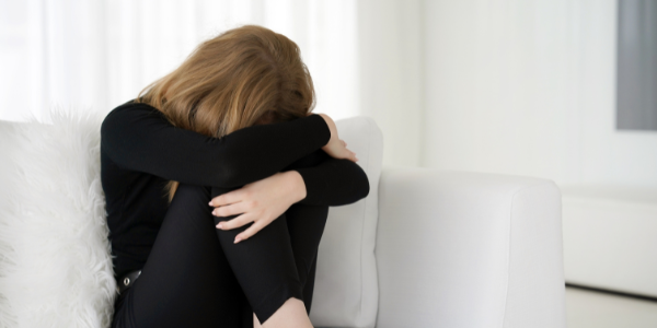 Woman sitting in grief, stress, fear