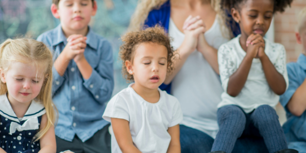 Children praying together.