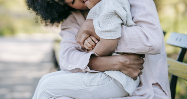 A mom giving a hug to her son.