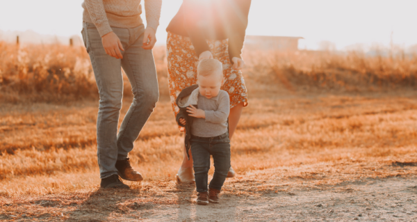 Mom and dad walking with toddler son.