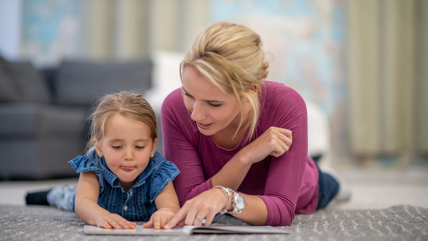 Mom and child reading a book.