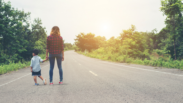 Mom and child on a road.