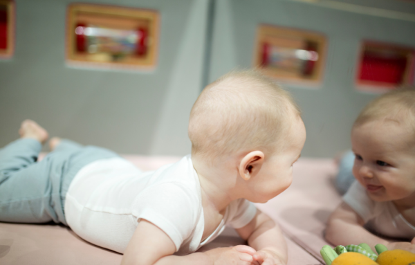 Pragmatic Milestone - Baby smiling at himself in the mirror.