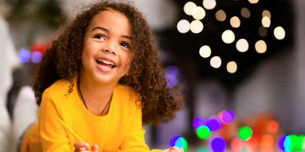 Little girl in front of a Christmas tree.