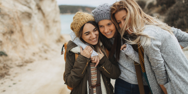 Three women hugging.