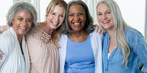 Women standing together overcoming loneliness.