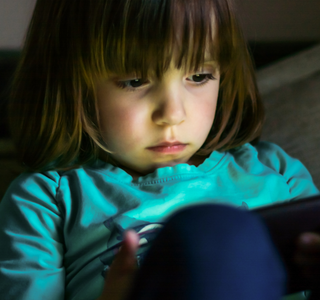 Child on an electronic device.