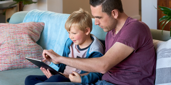 Father and son using technology.