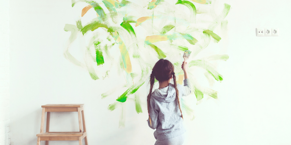 Child expressing herself by painting on the walls.