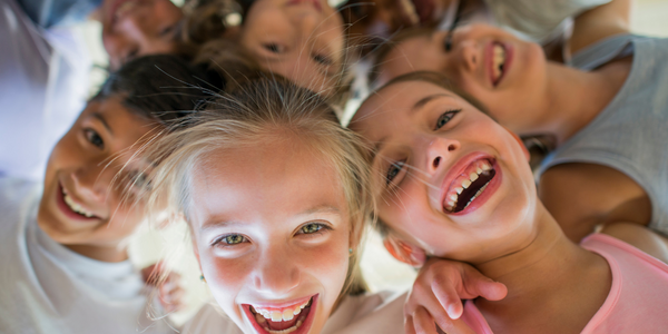 Children in a group smiling.