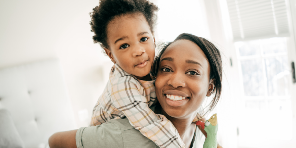 Mom and child smiling.