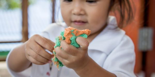 Child playing with play dough.