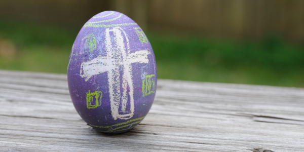 Easter egg with a chalk cross drawn on it.