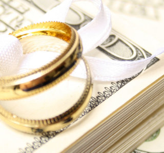 Wedding rings sitting on top of money.