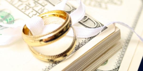 Wedding rings sitting on top of money.
