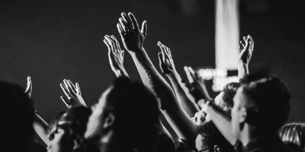 People raising hands during a worship time at church.