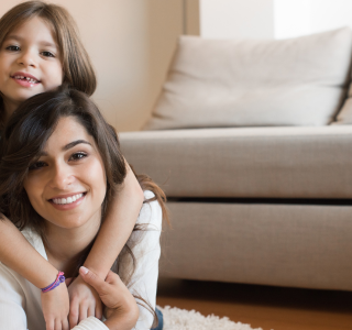 Child hugging mom from the back.